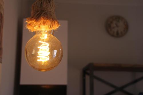 a glass light bulb hanging from a ceiling at B&B San Paolo Sweethome in Parma