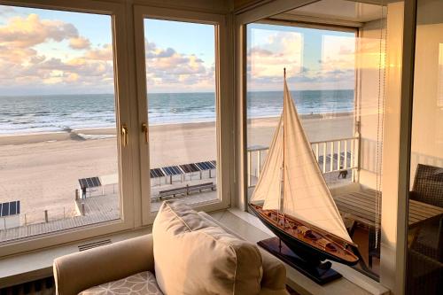 a living room with a sail boat on the beach at Residentie Rapallo Oostende with fantastic Sea View! in Ostend