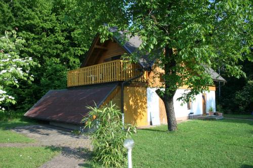 a house with a balcony on top of it at Ferienwohnung MaLu in Aich