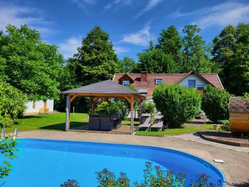 a swimming pool in a yard with a gazebo at Ferienwohnung MaLu in Aich