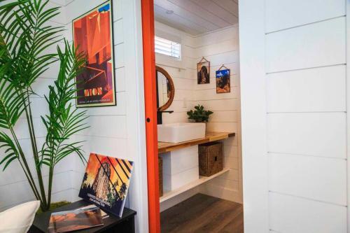 a bathroom with a sink and a mirror at Angels Landing Tiny Home in Apple Valley