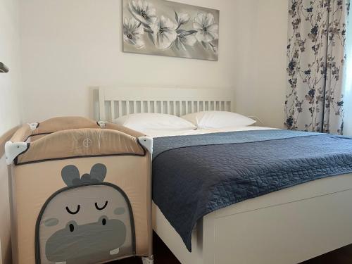 a bedroom with a bed with a hello kitty comforter at City Break Arena Zagreb in Zagreb