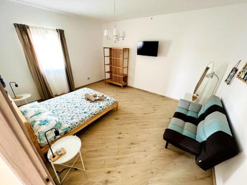 a bedroom with a bed and a tv in it at Villa Chimera in Pachino