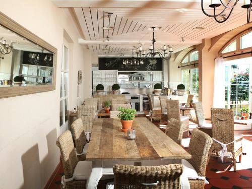 a dining room with a wooden table and chairs at Hotel Hirschen am See in Meilen