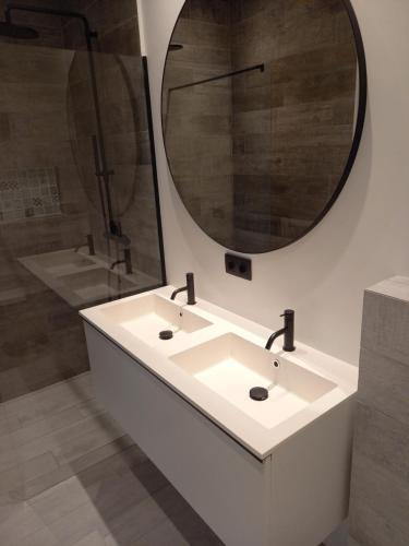 a bathroom with a white sink and a mirror at The Reef 28 Blue Bay Curacao in Dorp Sint Michiel