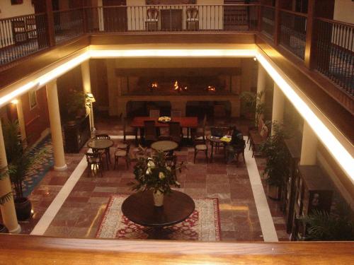 an empty lobby with tables and chairs in a building at Hotel Finca La Mansión in Llanes