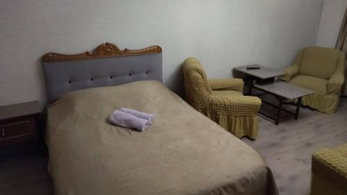 a bedroom with a bed with a purple pillow on it at Kandelaki in Tbilisi City