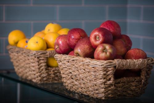 two baskets of apples and pears on a counter at Ocean Park Inn in San Diego