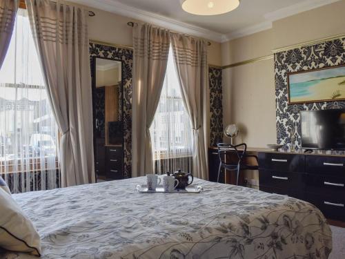 a bedroom with a bed with a tray on it at Divers Cottage in Herne Bay