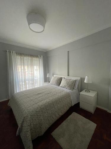 a white bedroom with a bed and a window at Parque Verde 1 - AL in Torres Vedras