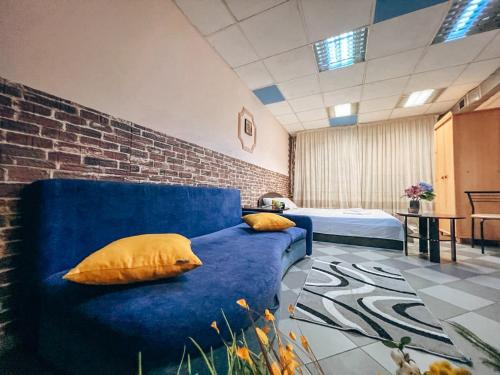 a blue couch with two pillows on it in a room at Guest House on Saksahanskoho Street in Kyiv