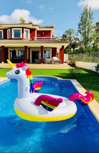 a unicorn float in a swimming pool in a house at Red House Bed & breakfast in Llucmajor