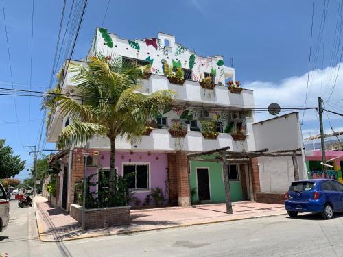 a building with a palm tree in front of it at Castillo Tulum in Tulum