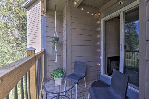 a porch with two chairs and a table on a house at Ski Shuttle and Pool Modern Silverthorne Condo! in Silverthorne