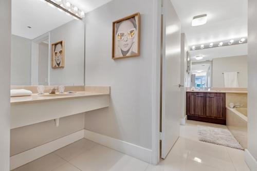 a bathroom with a sink and a mirror at Ocean Utopia in Miami