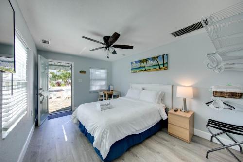 a bedroom with a bed and a ceiling fan at The Bungalows in St. Pete Beach