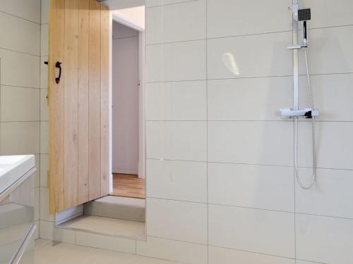 a bathroom with a shower with a glass door at Cornel Clyd cosy Corner in Cilcennin