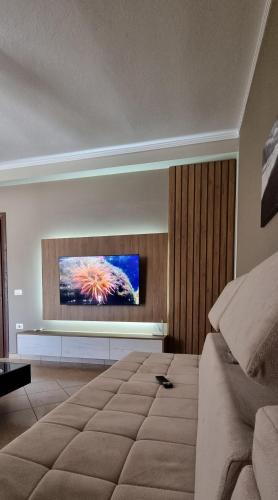 a bedroom with a television on a wall at Luis Penthouse in Berat