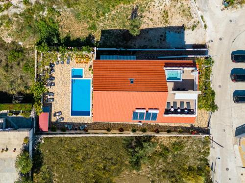 an overhead view of a building with an orange roof at La Perla Apartments in Sutivan