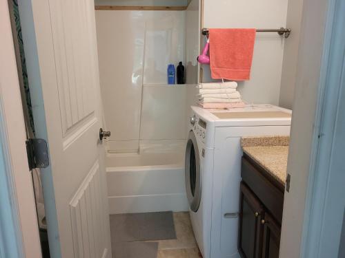 a bathroom with a washing machine and a shower at Vancouver Jenny's Guesthouse in Coquitlam