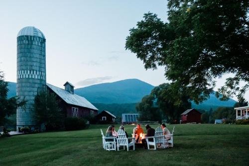 a group of people sitting around a fire on a lawn at Hill Farm Inn - Manchester in Sunderland