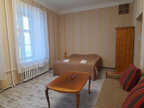 a hotel room with a bed and a table at Godart Rooms Guesthouse in Tallinn