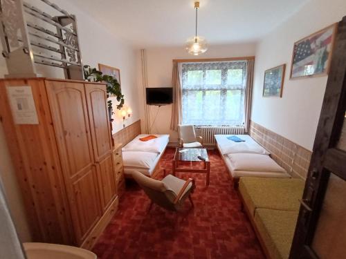 a living room with two couches and a window at Pension 21 in Prague