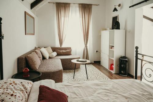 a living room with a bed and a couch at Terrazzo house in Subotica