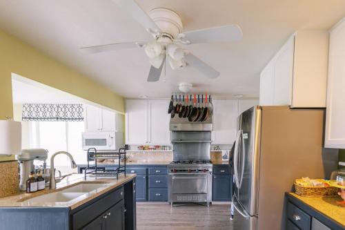 a kitchen with blue cabinets and a ceiling fan at Trumpeter Inn in Friday Harbor