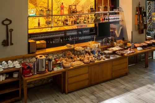 a bakery counter with a lot of food on it at Radisson Blu Belo Horizonte Savassi in Belo Horizonte