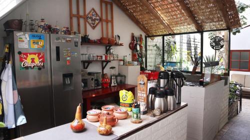 a kitchen with a refrigerator and a counter with food at Lunawasi Hospedaje in Lunahuaná