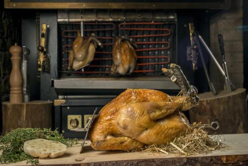 a turkey sitting on a cutting board in an oven at Hotel La Chaudanne in Méribel