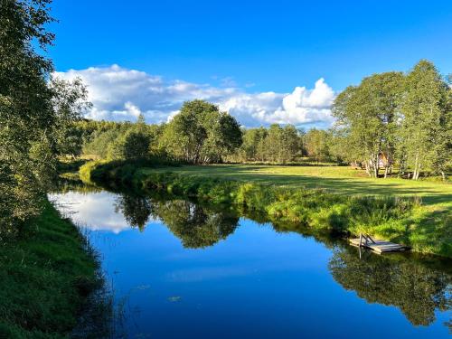 a river with a boat in the middle at Lux Glamping, Lammas 