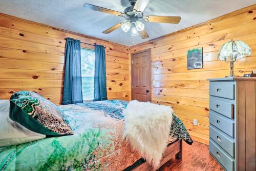 a bedroom with a bed and a ceiling fan at Charming Jamestown Cabin with Large Backyard! in Jamestown