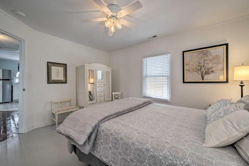 a bedroom with a bed and a ceiling fan at Bright Carolina Beach Cottage with Yard and Grill in Carolina Beach