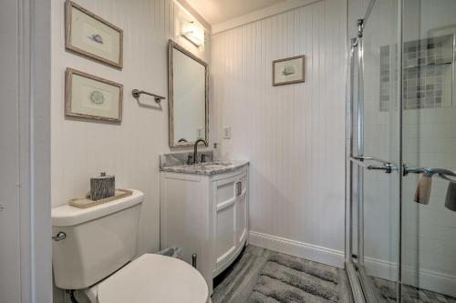 a bathroom with a toilet and a sink and a shower at Bright Carolina Beach Cottage with Yard and Grill in Carolina Beach