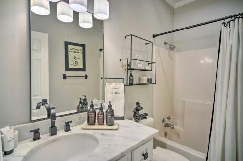 a white bathroom with a sink and a shower at Baton Rouge Game Day House with Chic Yard Space in Baton Rouge