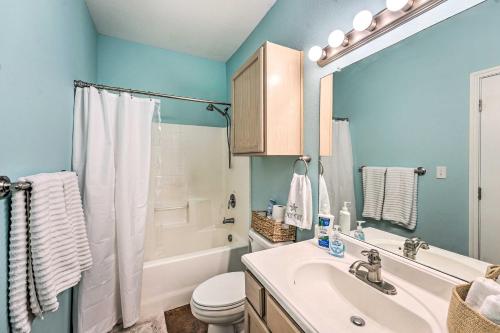 a bathroom with a sink and a toilet and a shower at Sunny Townhome with Pool Access about 1 Mi to Beach in Padre Island