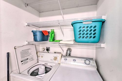 a laundry room with a washing machine and shelves at Sunny Townhome with Pool Access about 1 Mi to Beach in Padre Island