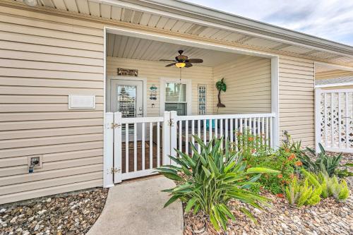 a house with a gate and a porch with a fan at Sunny Townhome with Pool Access about 1 Mi to Beach in Padre Island