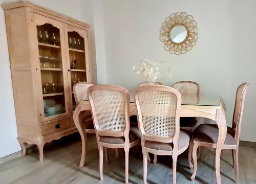 a dining room table with chairs and a mirror at El Patio Grande 