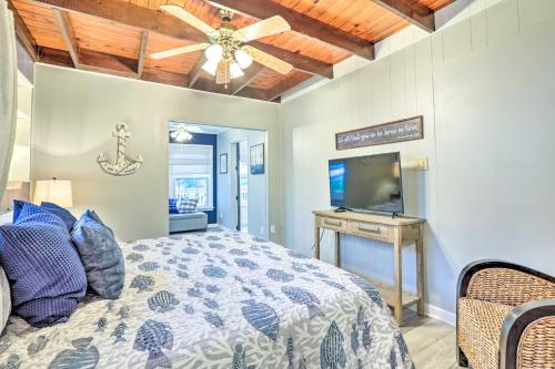 a bedroom with a bed and a flat screen tv at Waterfront Home Spectacular On-Site Fishing! in Panacea