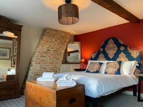 um quarto com uma cama grande e uma parede de tijolos em Innkeeper's House em Easingwold