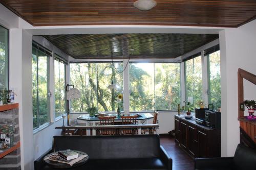 a living room with a couch and some windows at Pousada Laura e Emílio in Osório