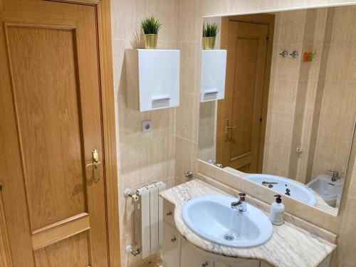 a bathroom with a sink and a mirror at Apartamento grande, 2 dormitorios, garaje gratis in Madrid