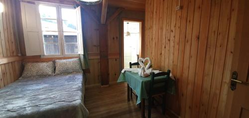 a bedroom with a bed and a table in it at Casarão Biazolli in Farroupilha