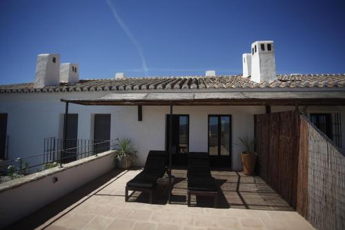 a balcony of a house with chairs on it at La Posada del Torcal in Villanueva de la Concepción