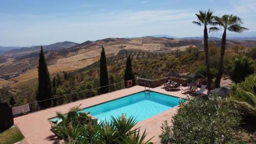 a swimming pool with a view of a mountain at La Posada del Torcal in Villanueva de la Concepción