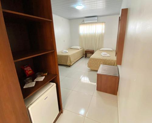 Ένα ή περισσότερα κρεβάτια σε δωμάτιο στο Hotel Alexânia