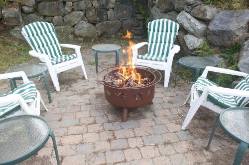 a group of chairs and a fire pit in a yard at Center Harbor Sutton House B & B in Center Harbor